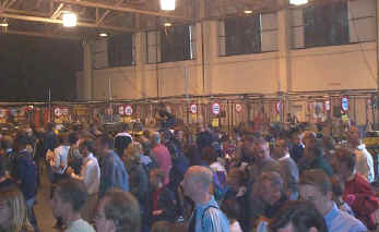 Mass crowds of people look into the pits while waiting to be led into the arena for the next show.